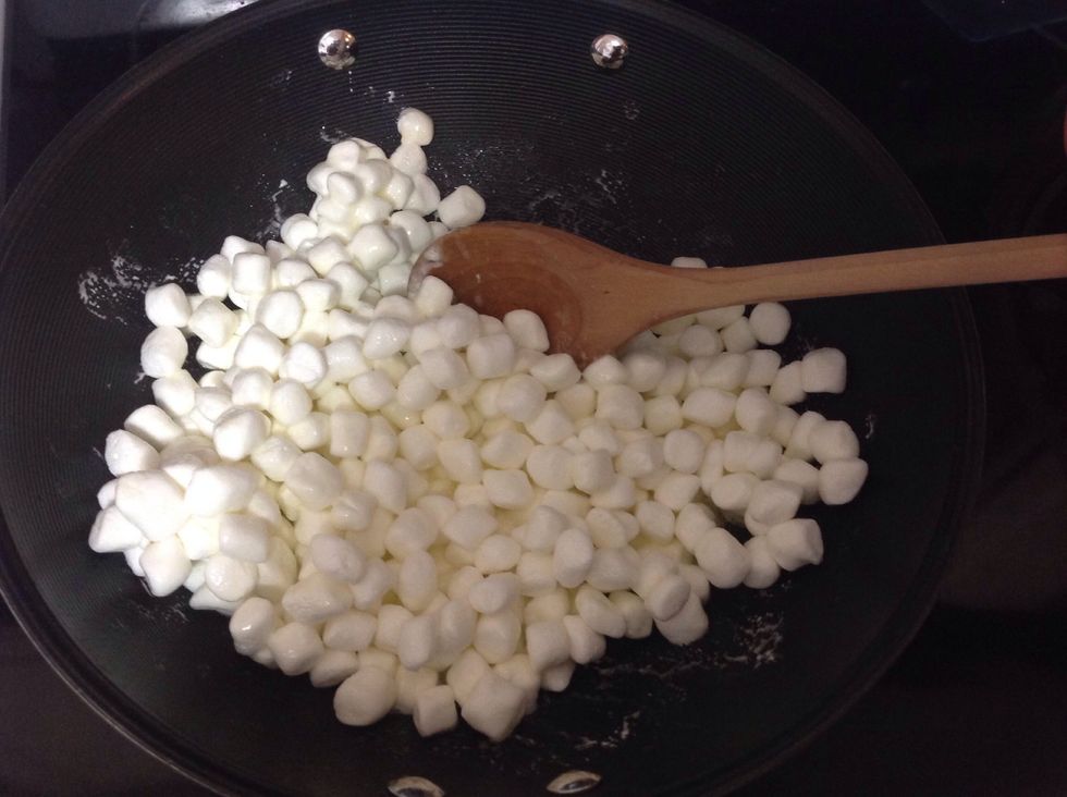 Once the butter has melted, put in all of the marshmallows. Stir until completely melted.