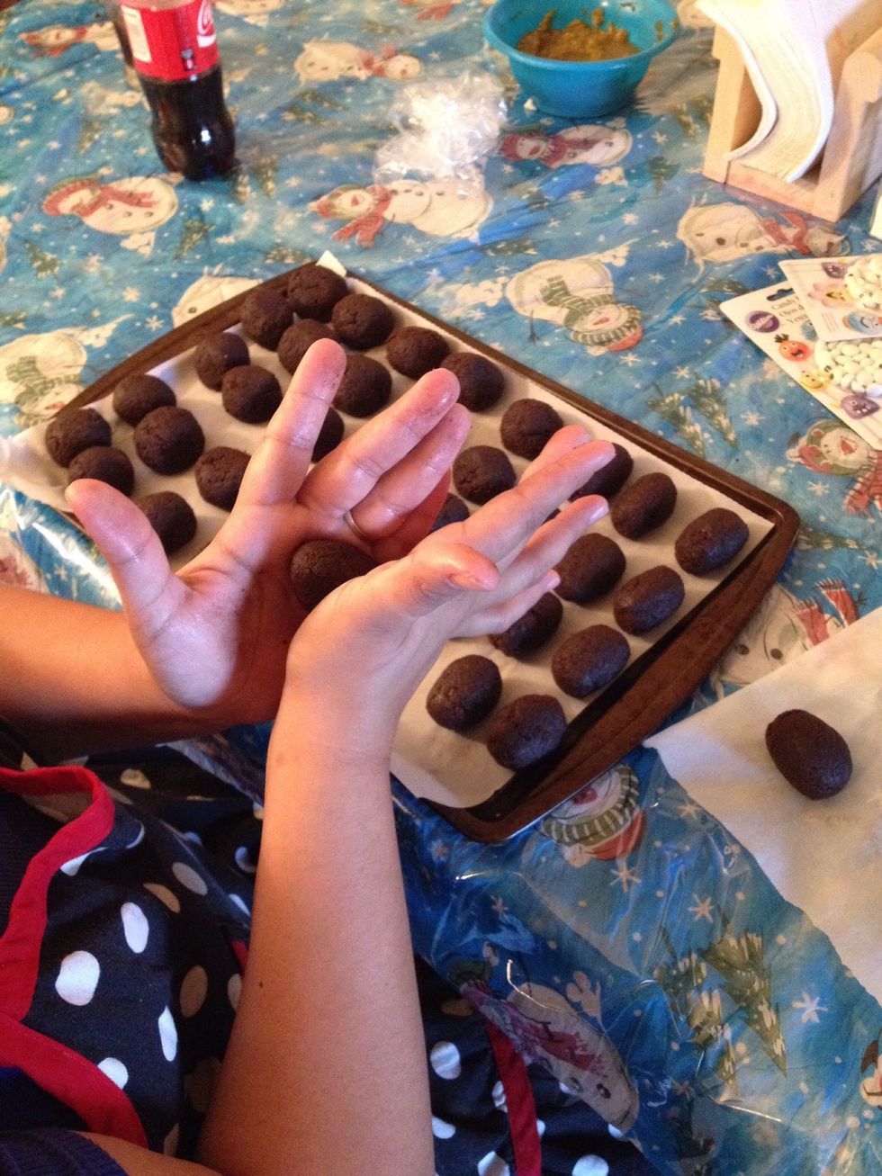 Once the cake balls have been in the fridge for a little while, take them out and you going to roll them into an owl shaped, oval-shaped ball. Return the balls to the fridge to stay firm.