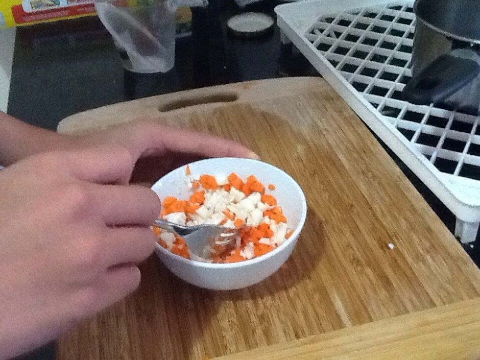 Once the carrots are chopped up, place it into the bowl with cauliflower and mix it up with a spoon, fork or chopsticks.