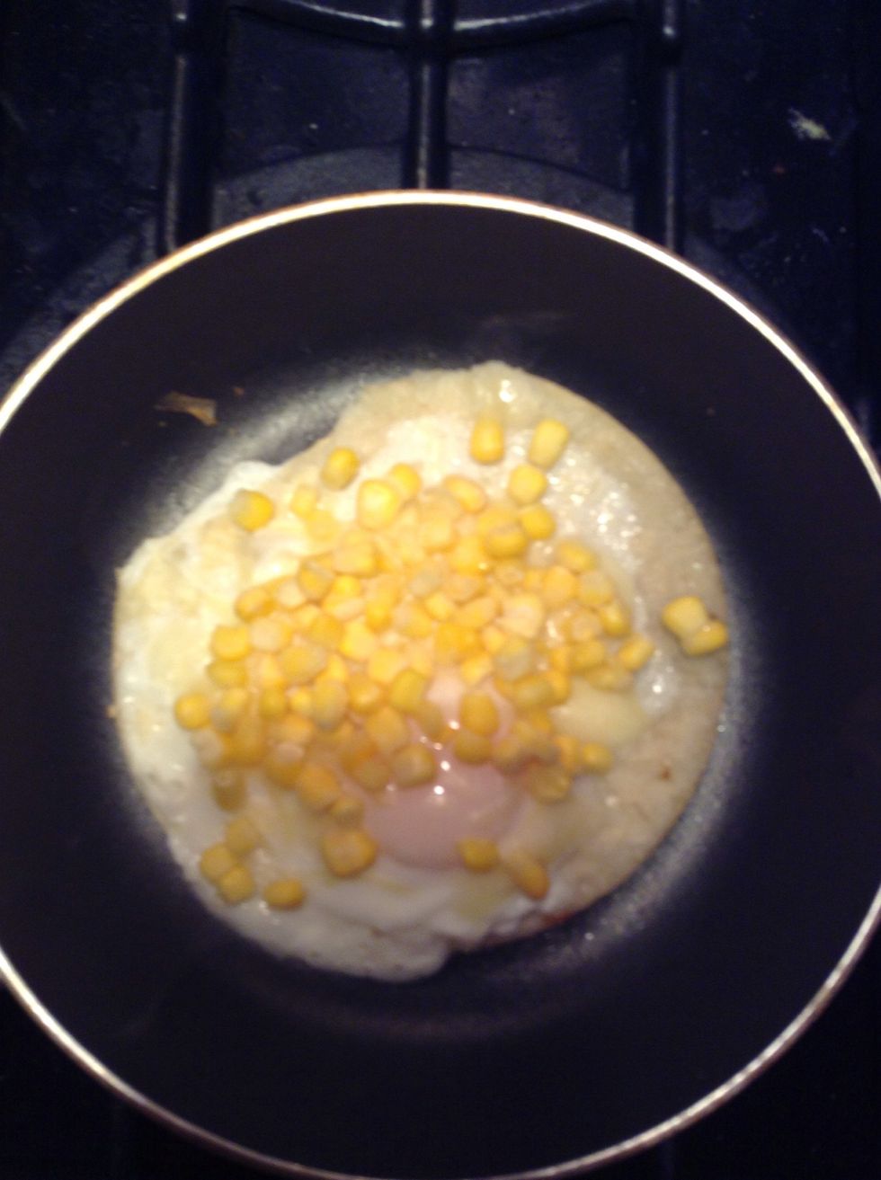 Once the cheese is melted, add the corn on top.