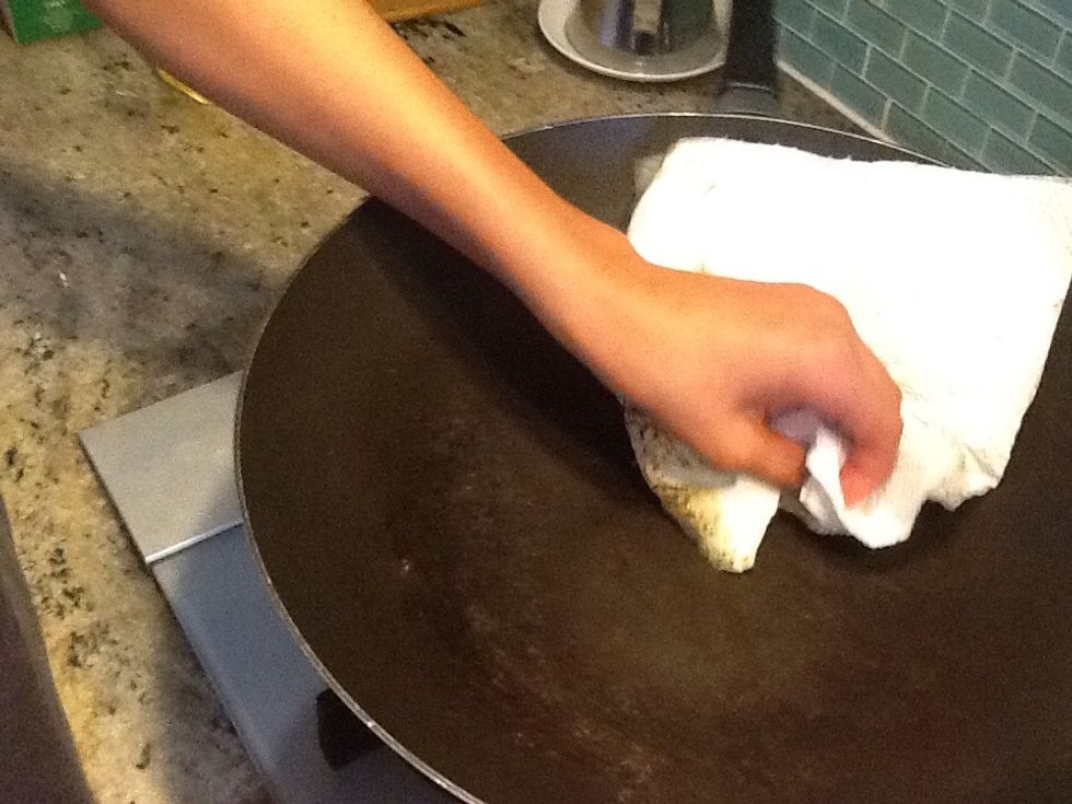 Once the chicken is cooked place on a plate and wipe down the wok