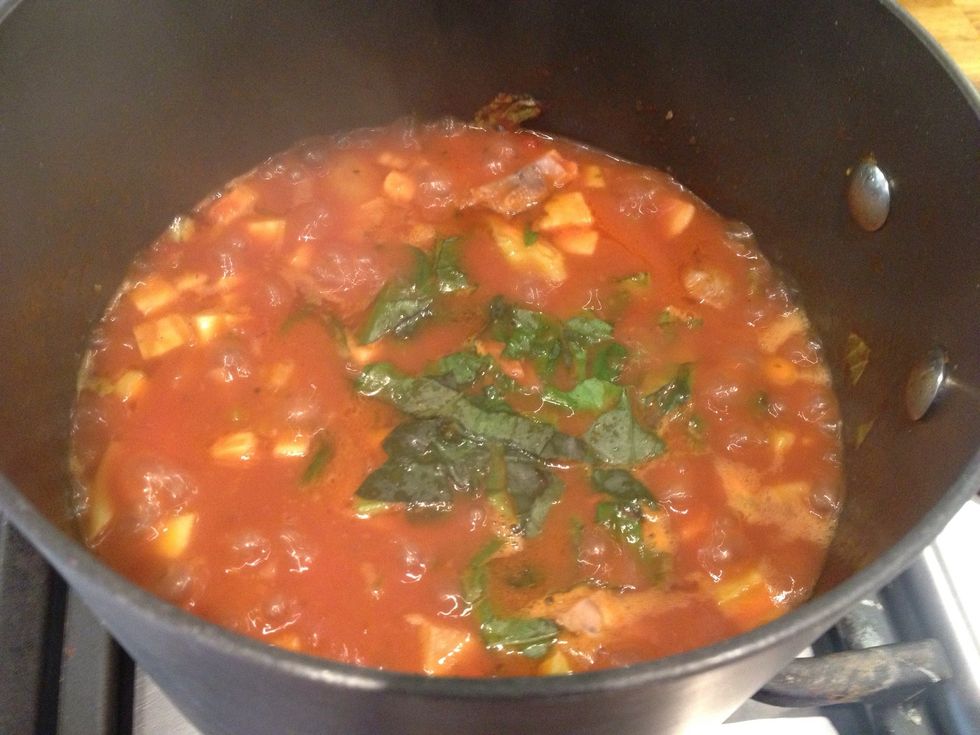 Once the chicken is heated through. Add a sprig of chopped basil