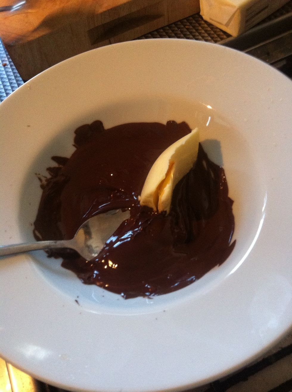 Once the chocolate has melted add butter and stir.