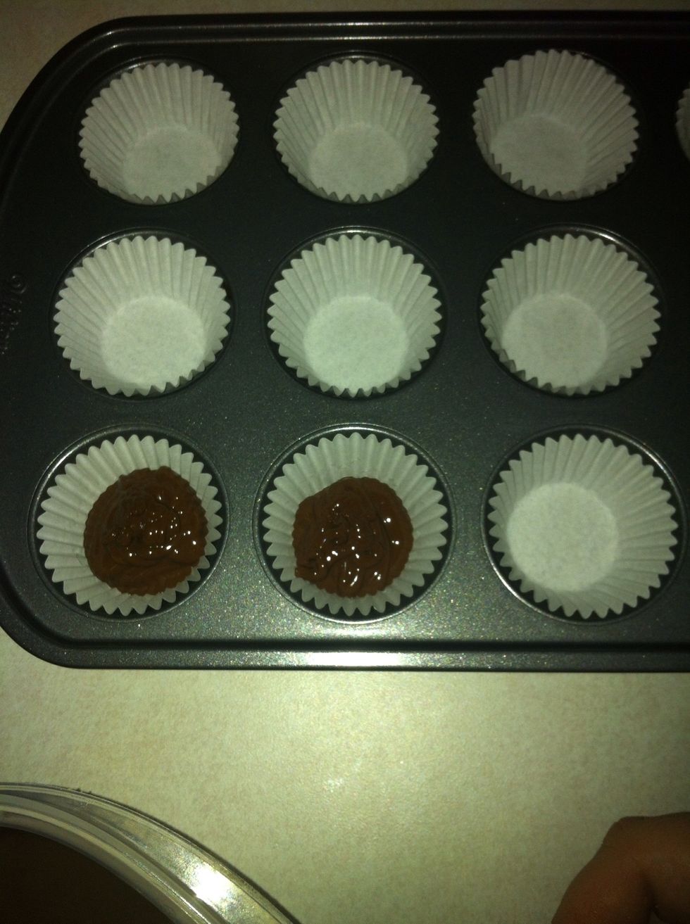 Once the chocolate is completely melted pour (or scoop) it into the paper liners. Covering approximately 1/4 of the cup.