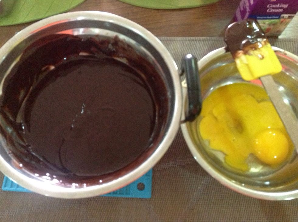 once the chocolate is melted evenly, cool it down and add in yolk one by one. make sure the chocolate is just warm, we don't want scrambled eggs in the chocolate.