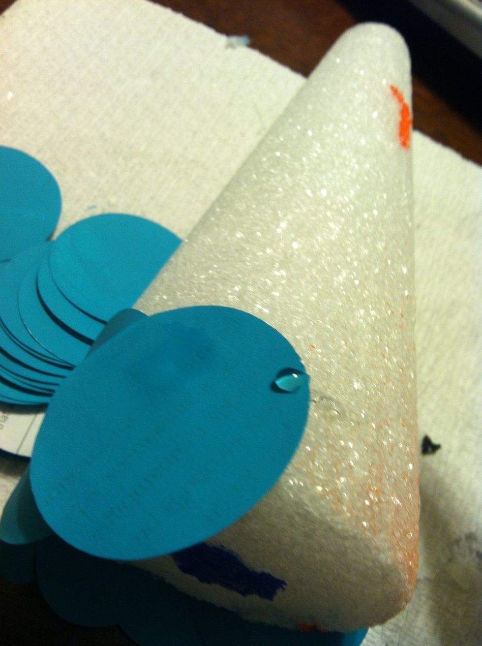 Once the circles are completely dry, hot glue them to the cone starting at the bottom and working your way up.
