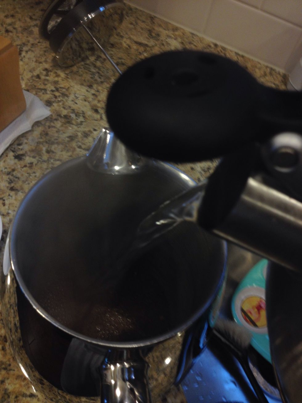Once the coffee is ground and the water is 30 seconds off the boil, pour water into the French press until half full.