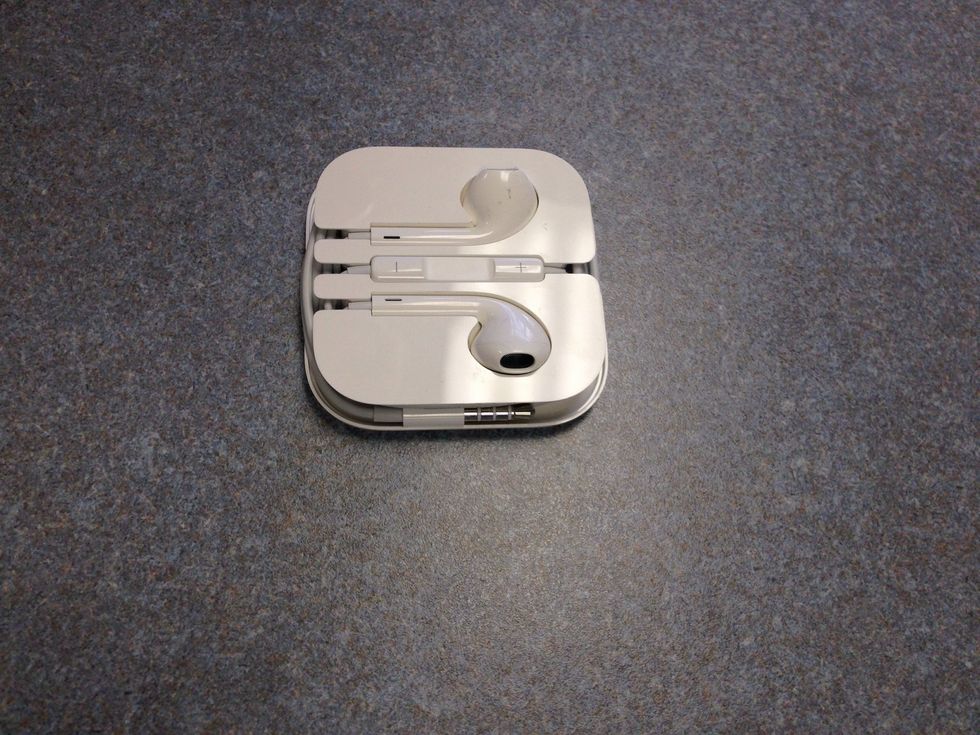 Once the cord is fully wrapped, get the auxiliary male connector (the metal end of the cord that goes into your devices) and place it along the right side as seen in the photo.