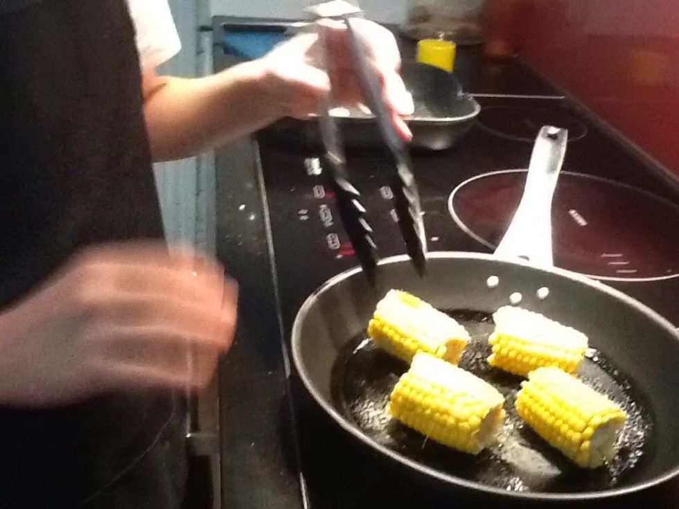 Once the corn has been microwaved tenderly, lightly spray corn with oil, cooking it in the pan, turning frequently for 5 minutes or until lightly charred.