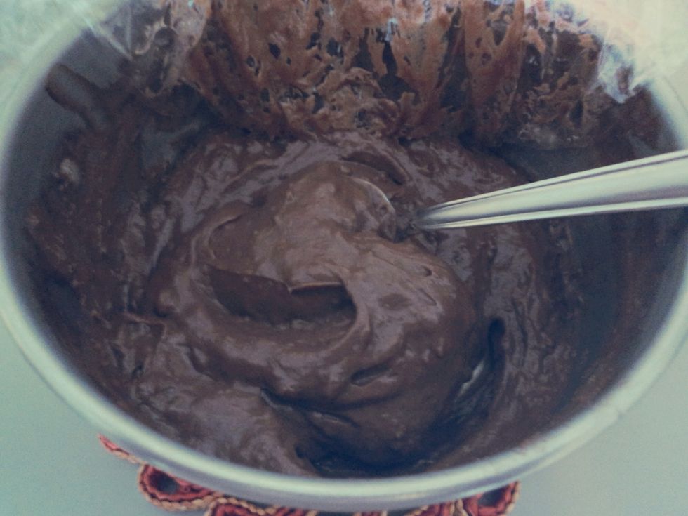 Once the cornets have cooled down, remove the plastic wrap from the chocolate custard and mix to soften. Fill a pastry bag with the chocolate custard.