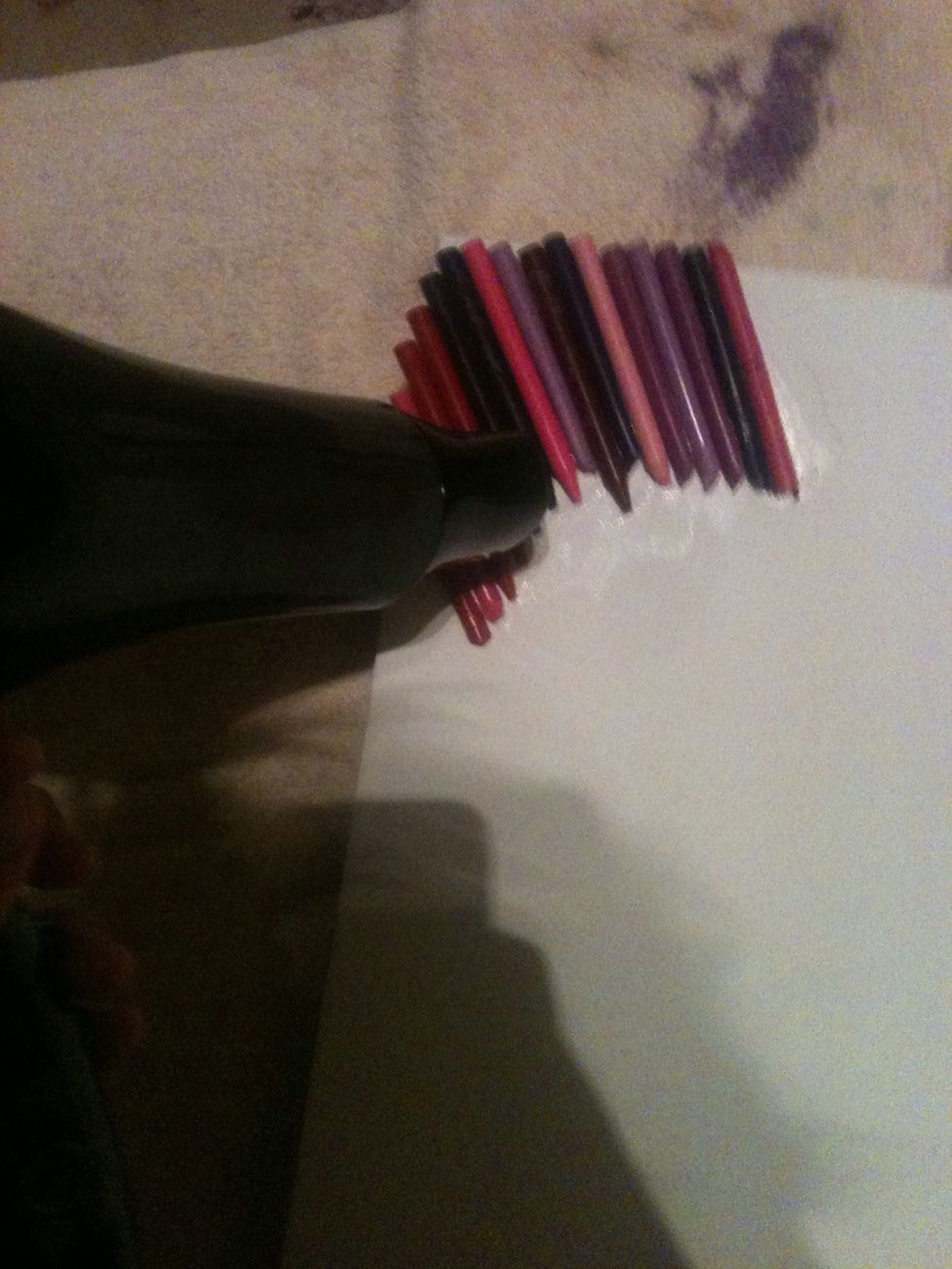 Once the crayons are dry, get your blow dryer and hold it I front of the crayons and wait for them to melt