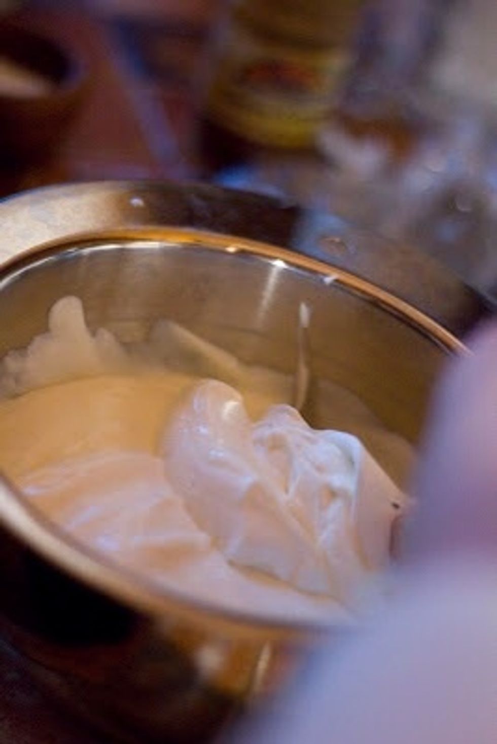 Once the cream is whipped, fold it gently into the chilled lime yogurt mixture.