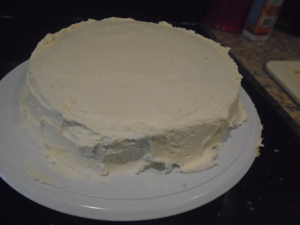 Once the crumb coat is chilled ( hard) spread a thick layer of frosting on the cake.