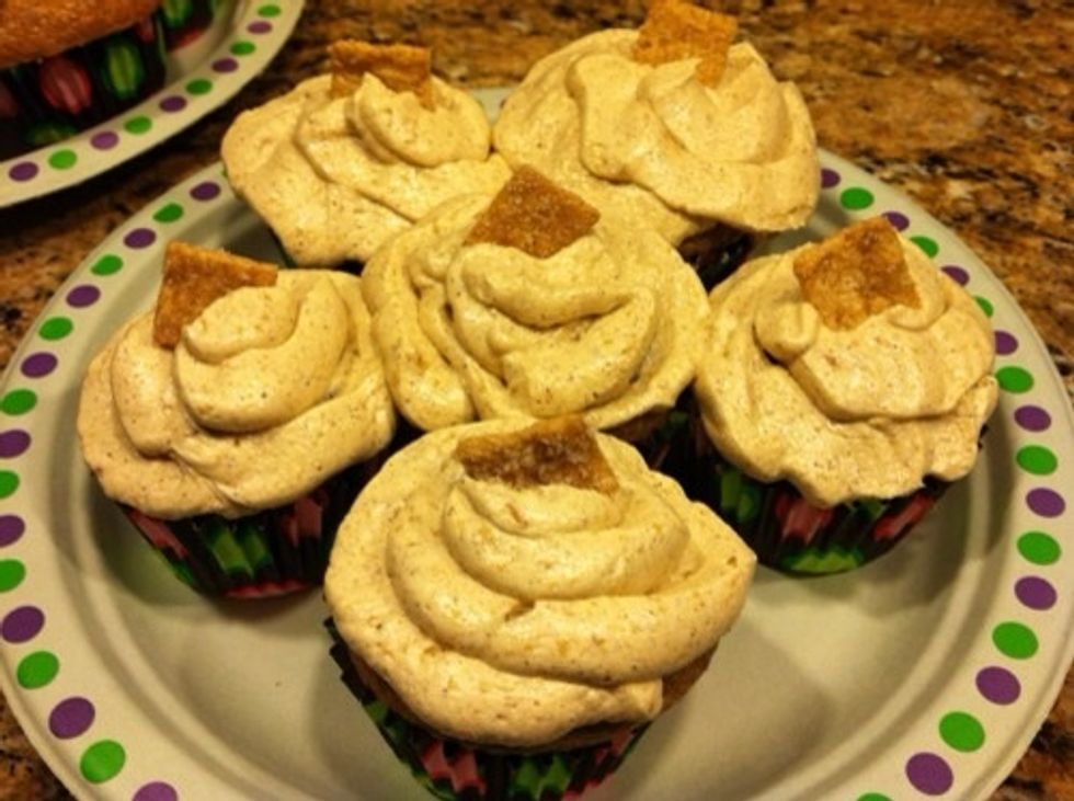 Once the cupcakes are cool, frost them. To make them look fancier, pipe on the frosting and garnish with a Cinnamon Toast Crunch square. Enjoy!
