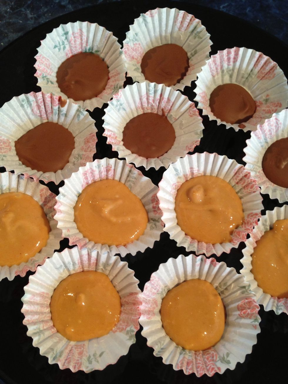 Once the cups are cool enough take them out of the fridge and with a teaspoon place a generous amount of the peanut butter mix on top of the chocolate