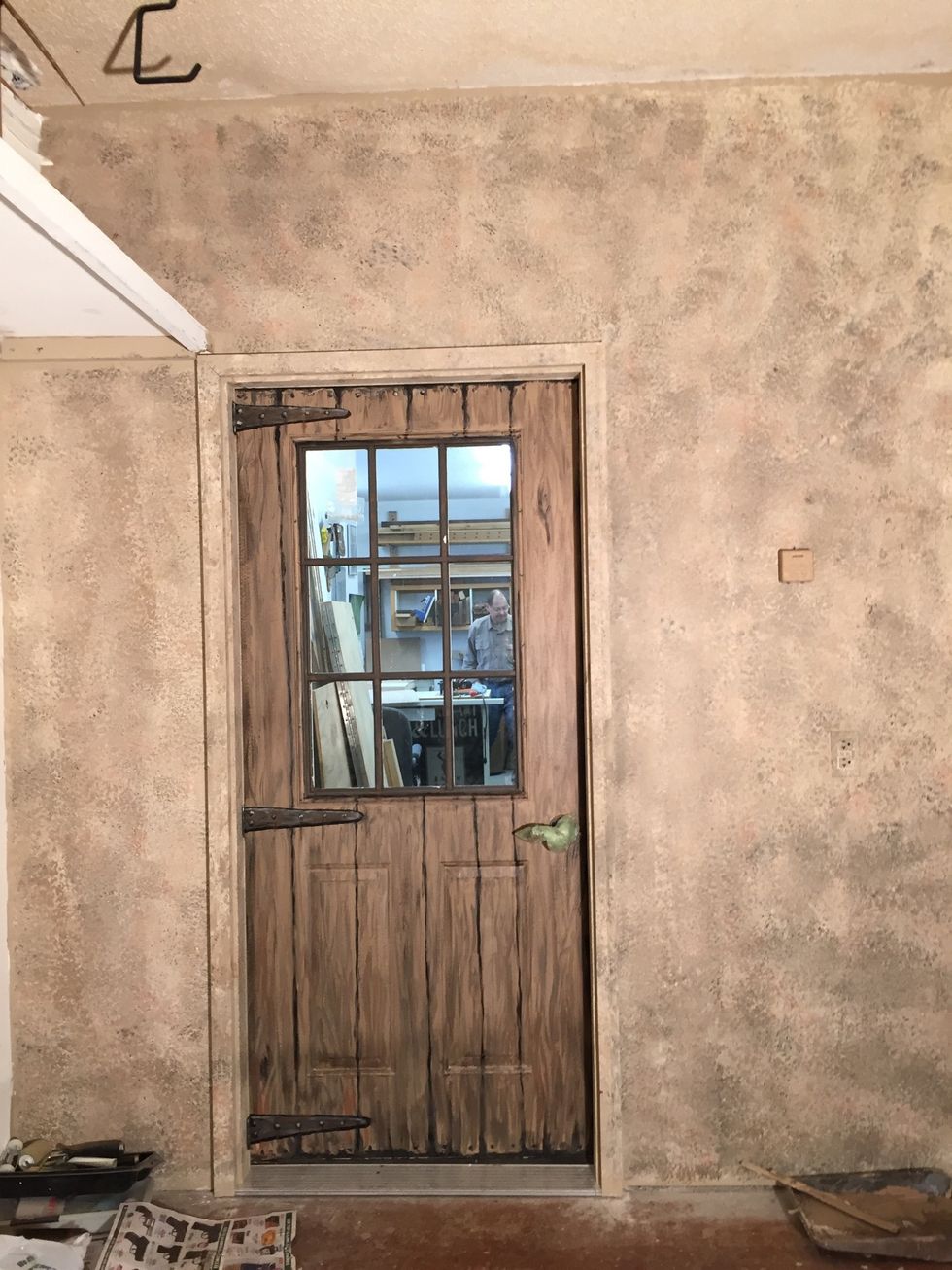 Once the door was done, it was back to the wall. The faux painting, done, it's taking on a textured stone look.