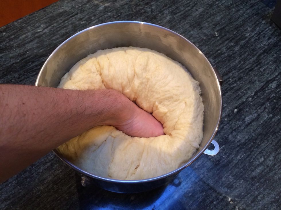 Once the dough has doubled you're ready to punch it down. Using a straight first evenly punch down the entire surface. Do not turn your wrist when punching!
