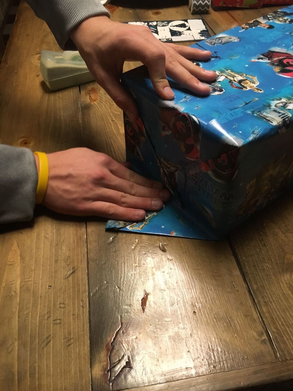 Once the edges are creased, fold them inwards. Tape the edges down to secure them in place.