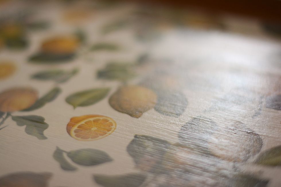 Once the first application dries apply a second coat.  Just keep in mind if you want this to be fully waterproof you may have apply an outdoor acrylic or enamel sealer after the Mod Podge dries.