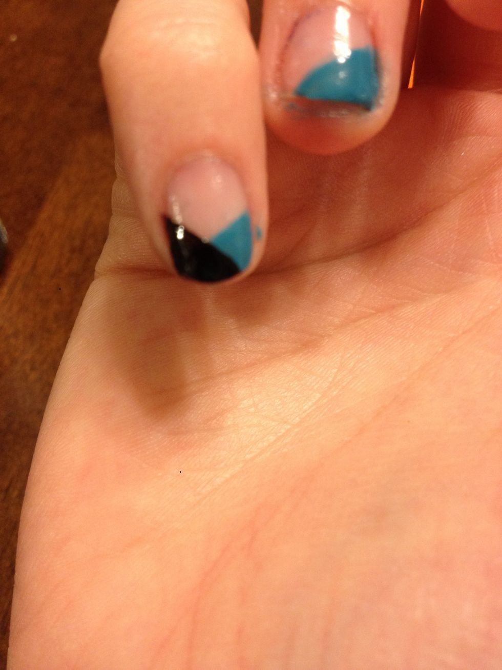 Once the first color (of your choice) has dried, add an opposite stripe of black, it shall Look like a V
