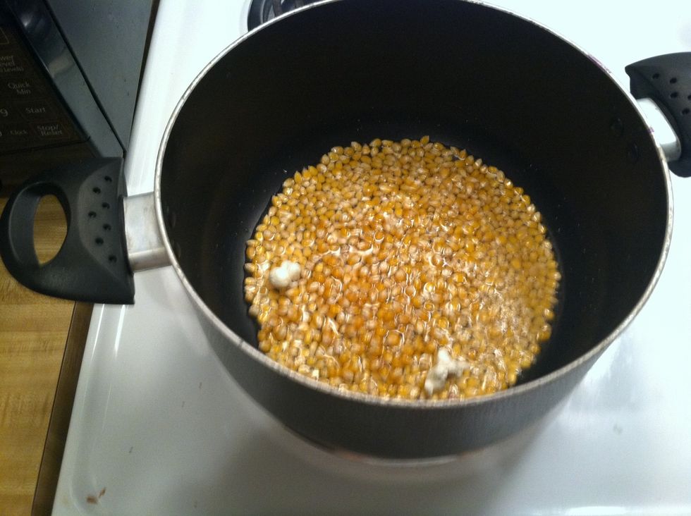 Once the first two kernels pop you know the oil is hot enough to add the rest of the popcorn about two cups should be enough to make a large bowl of popcorn.
