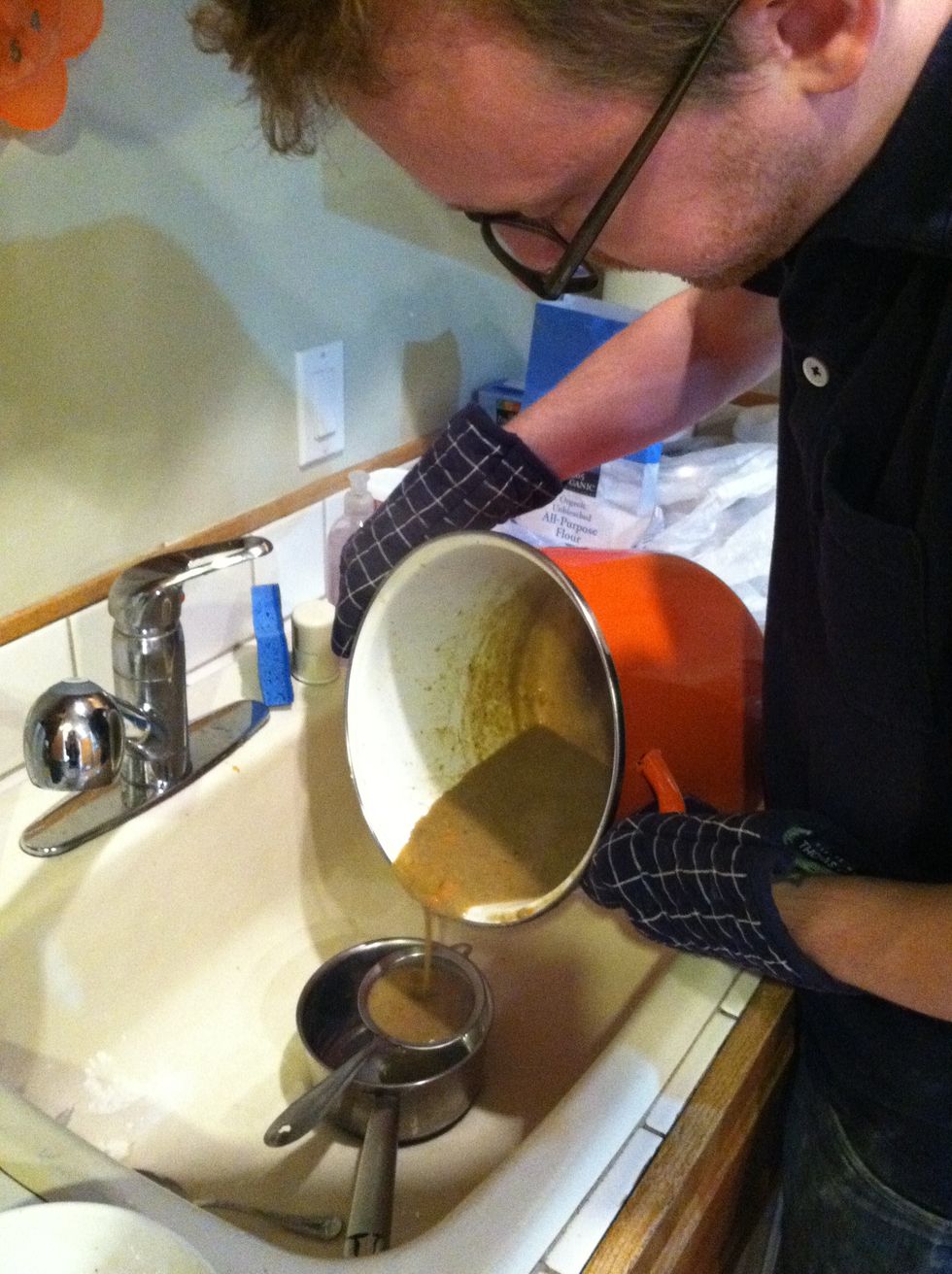 Once the gravy is cooked, strain out the meat and veggies using a dense strainer. If the gravy won't strain, use a whisk in the strainer to help liquid get through. Discard meat and veggies.