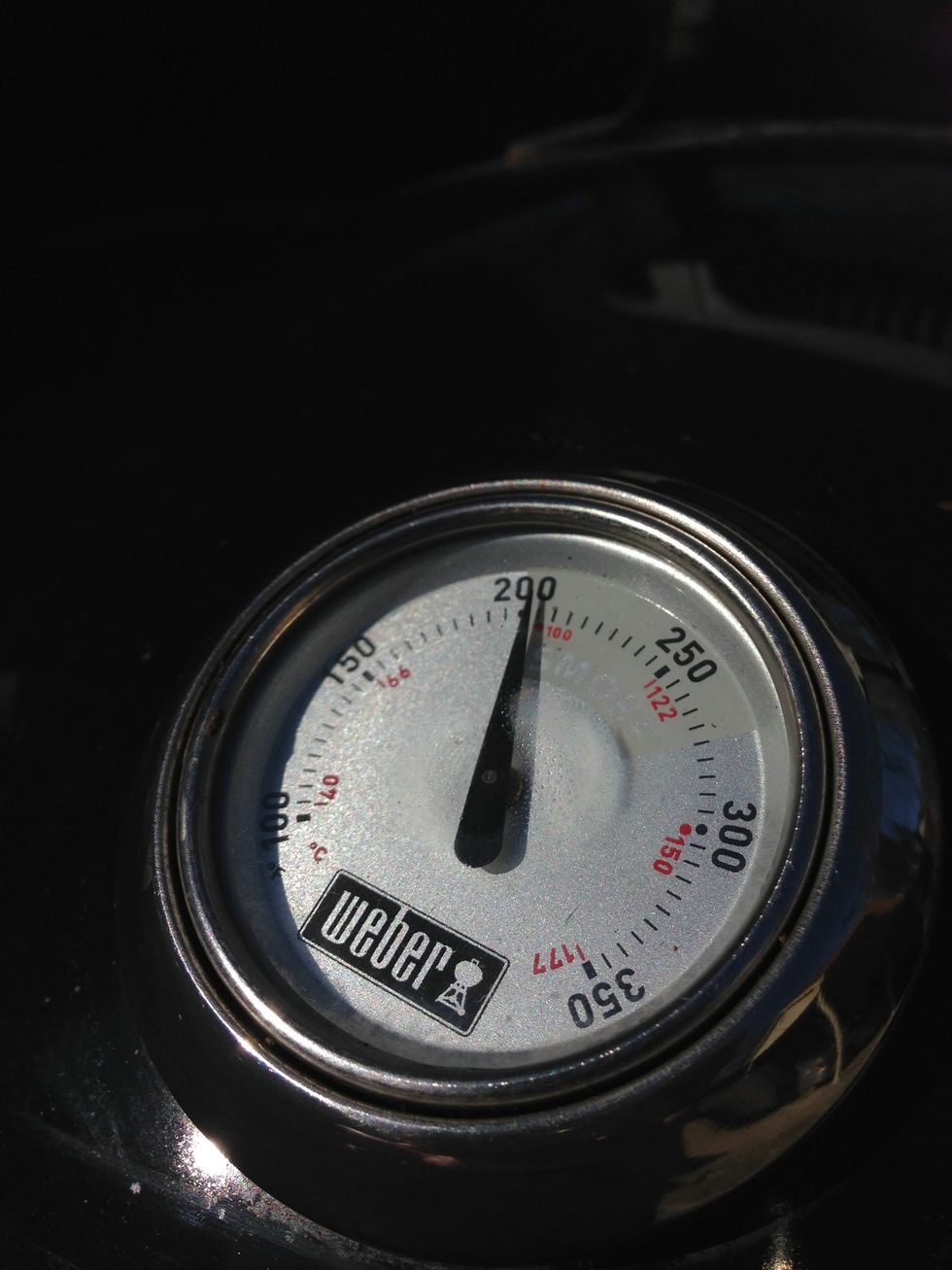 Once the heat gets into the smoking zone - 200-300 degrees depending who you talk to - it's time to add your brisket and wood chips to the smoker.