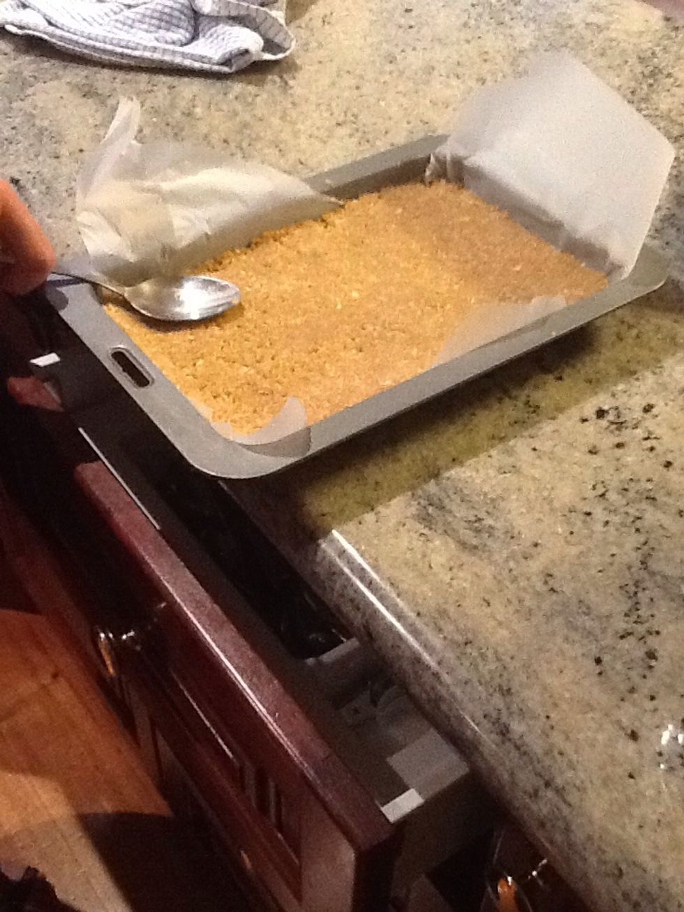 Once the ingredients have been blended, place the hard mixture into a container or on a tray, as demonstrated above. Than firmly press down to fill the entire space on the tray and make it spread even