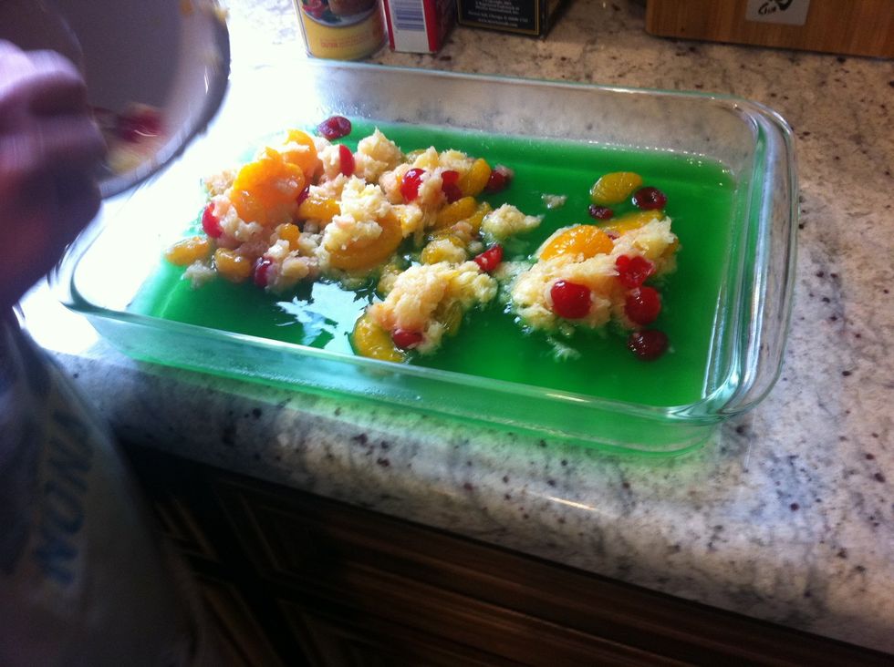 Once the jello is almost set, add the fruit. Then the cream.