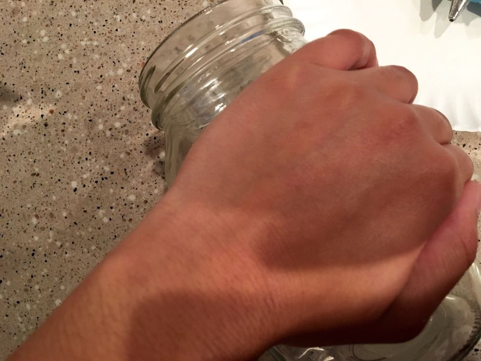 Once the leaf is on the jar, hold down the leaf so it sits evenly on the jar and won't budge. Make sure to glue down parts that aren't sticking.