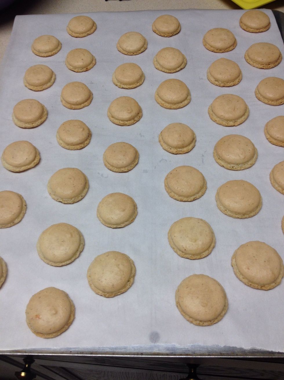 Once the macarons come out of the oven, let them sit on the baking sheet for 5 minutes.  Then take them off and place them on a cooling rack until completely cooled