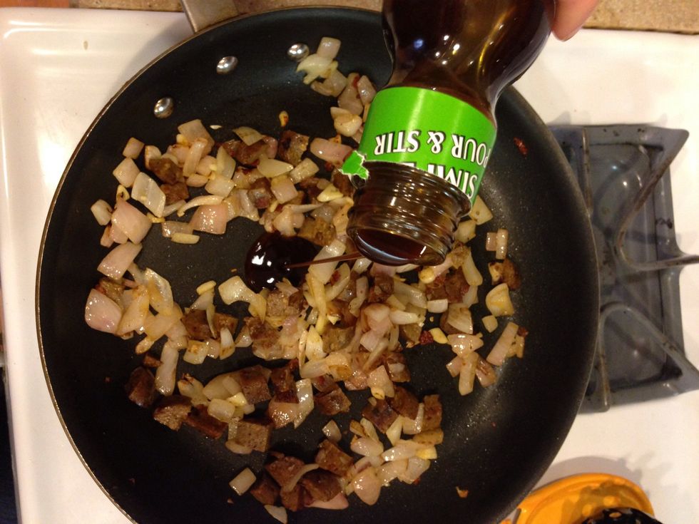 Once the meat and onions reach your desired level of cooked-ness (about 5-7 min), add a little of your sauce. Stir and cook for an additional minute.