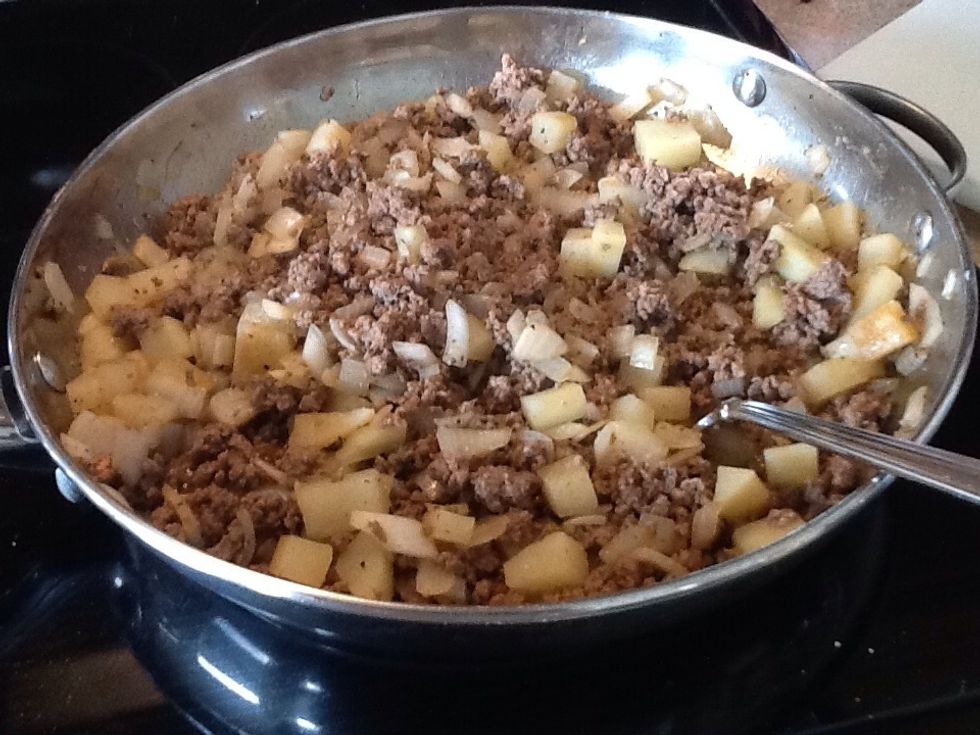Once the meat is nice and browned, and the onions are pretty well cooked, the potatoes will still need to cook some more. This is what you want to see before you proceed to the next step.