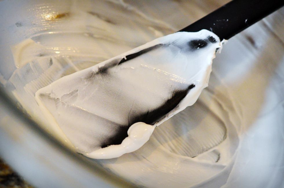 Once the mixture has thickened a lot and is gathering around the beaters, use a silicone spatula to scrape the marshmallow mixture into the prepared pan.