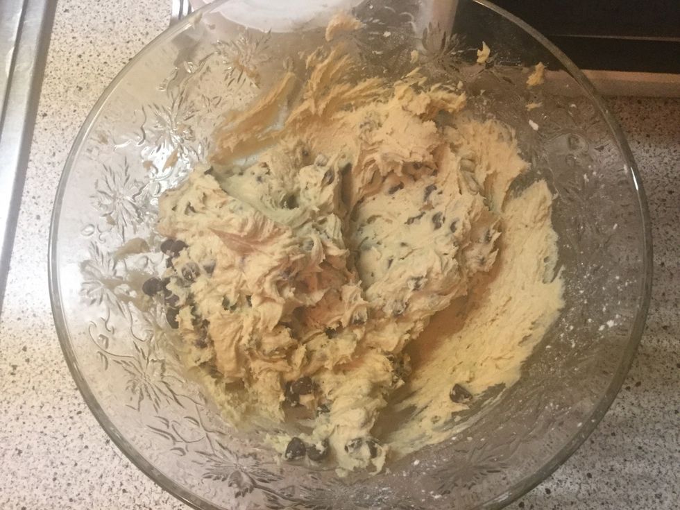 Once the mixture is creamy, add the chocolate chips and mix WITH A LARGE SPOON. Mixing the dough with the electric mixer may break it. I am not being held responsible for that. Be smart, please.