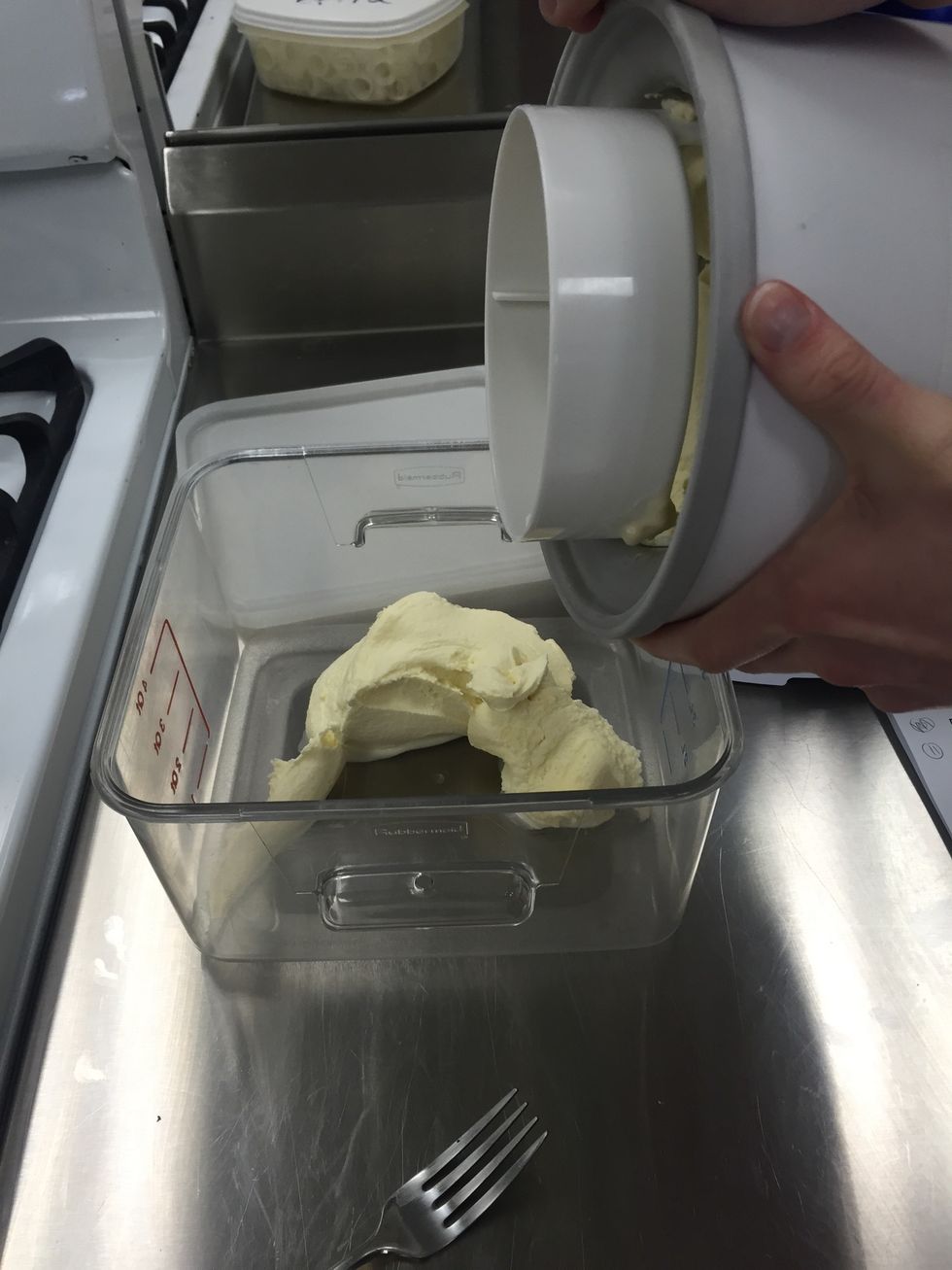 Once the mixture is softly frozen, transfer half of it into the storage container.