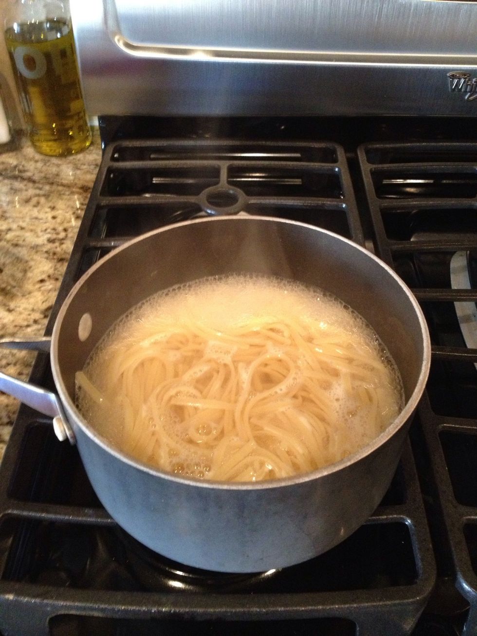 Once the noodles get soft, drain and then add your left over spaghetti sauce.