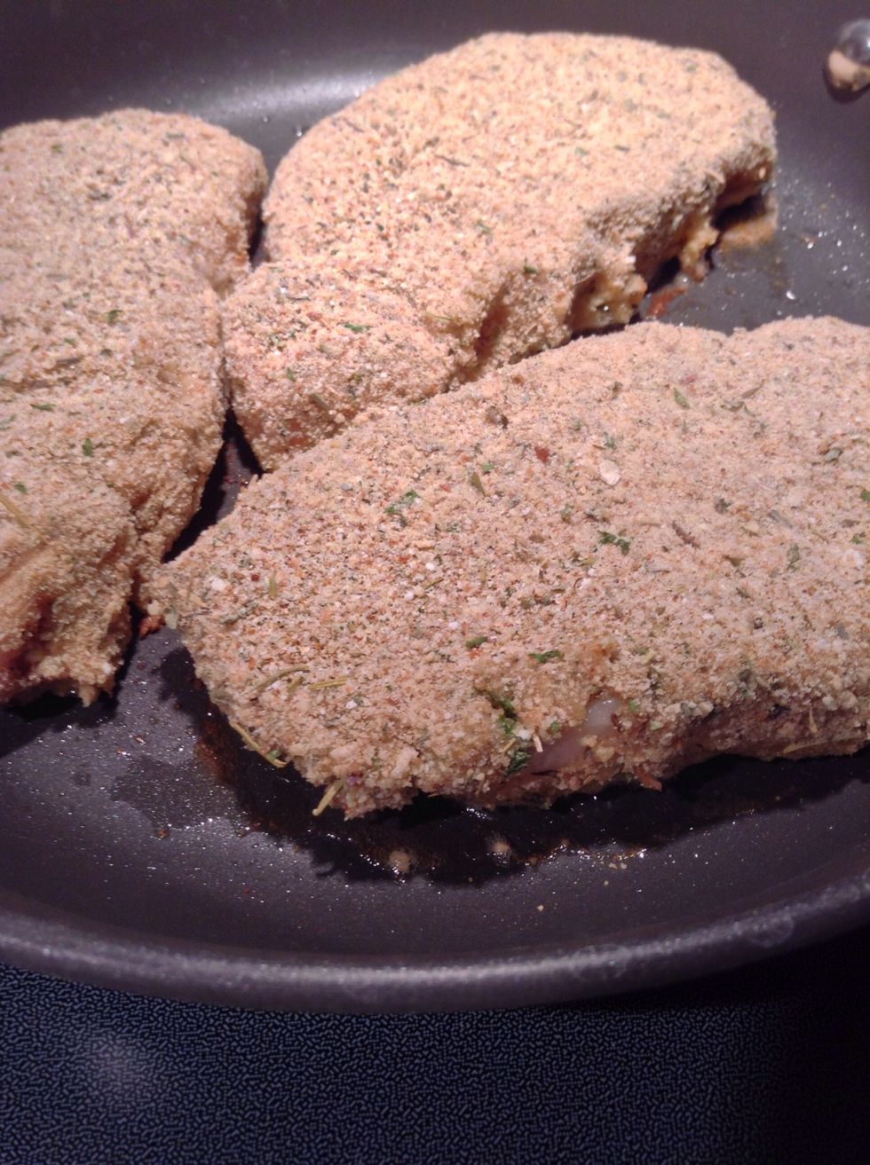 Once the oil is heated place breaded pork chops into the skillet. Slightly move them around once they get into the skillet this will prevent them from sticking.