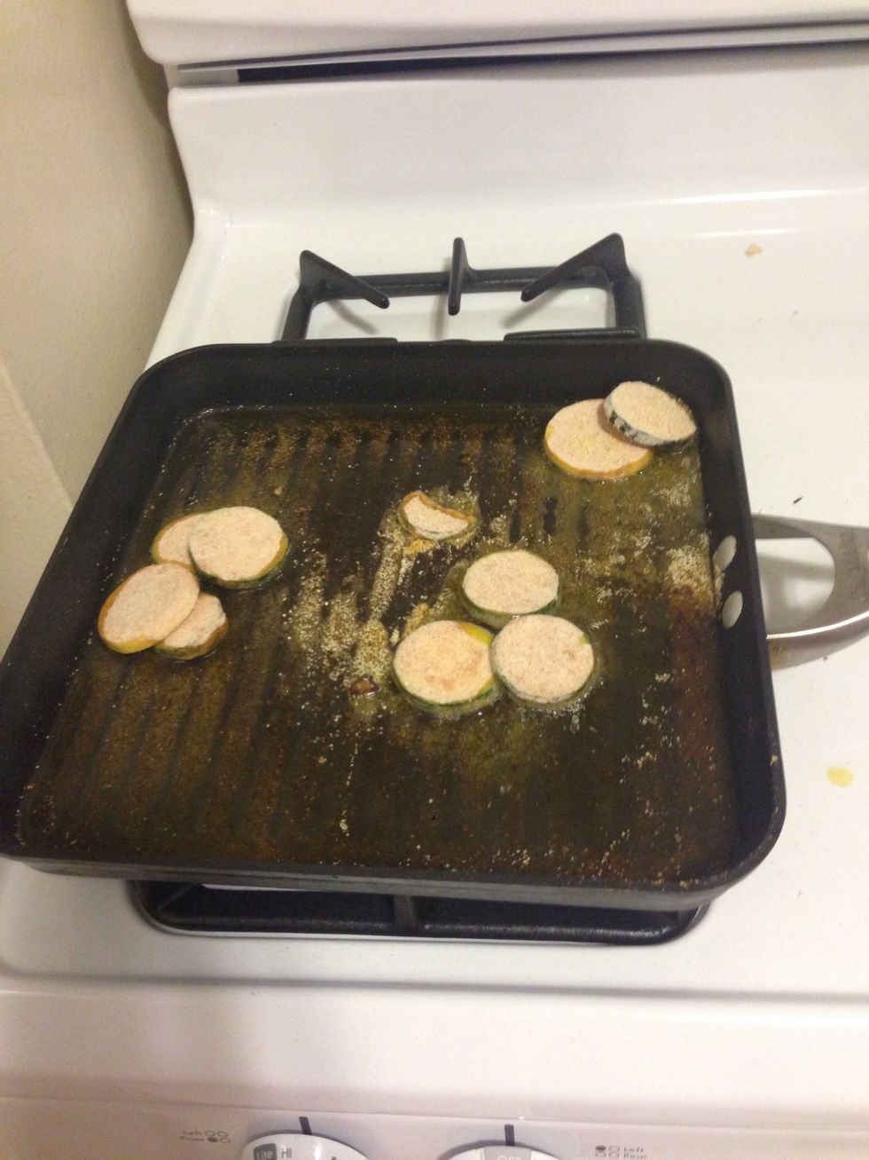 Once the oil is hot, add the slices in. Make sure to shake off loose batter or it will make a mess of your oil.