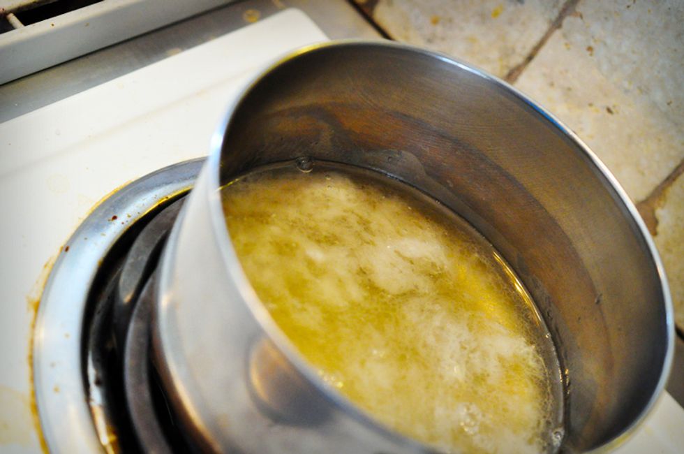 Once the oils are melted pour in the tea\u2014it should still be a bit warm at this point. Ensure the mixture heats through so everything is the same temperature and liquid.