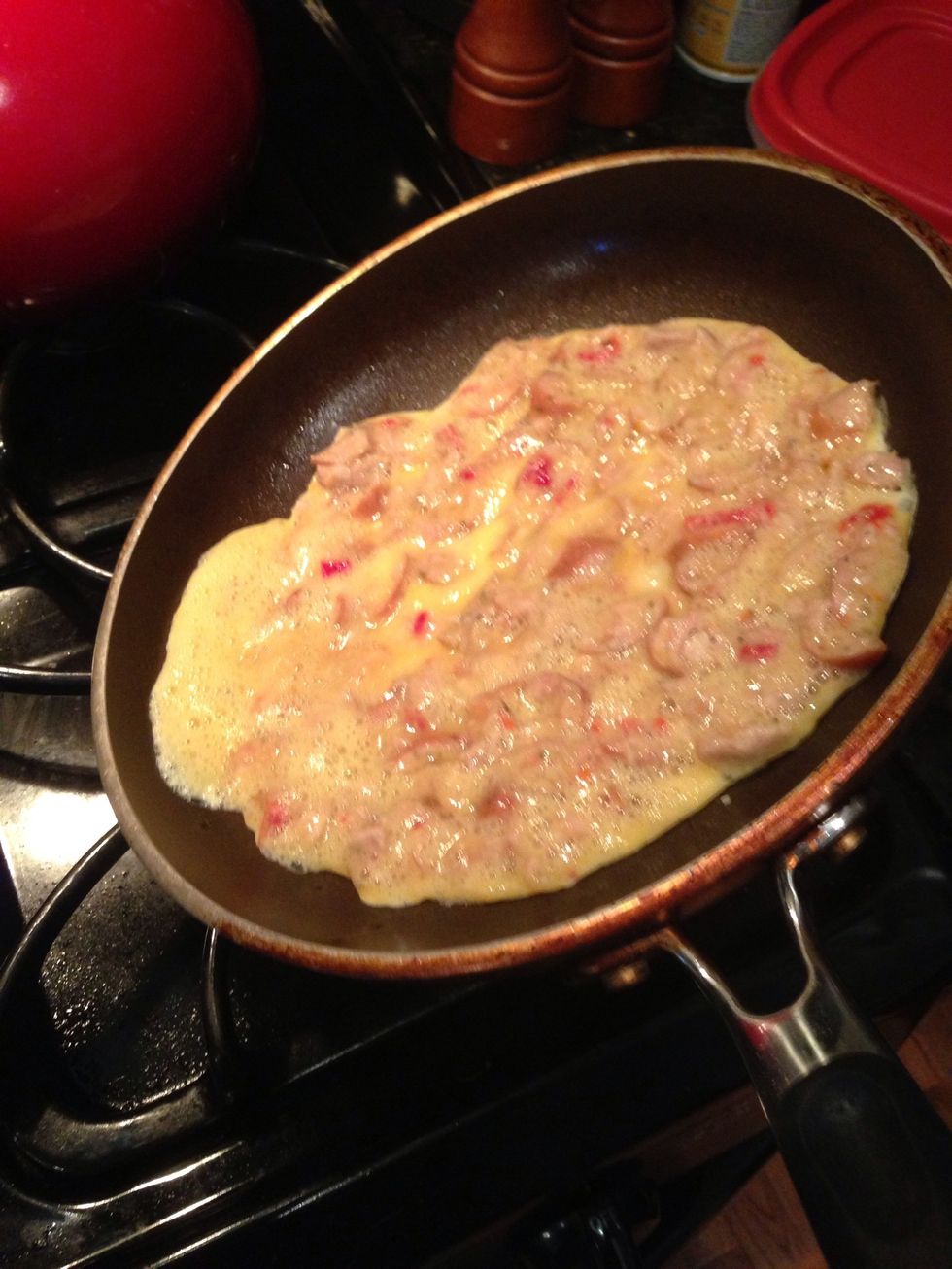 Once the omelette starts to form, tilt the pan to spread the batter around the edges. This will make the flipping easier also!