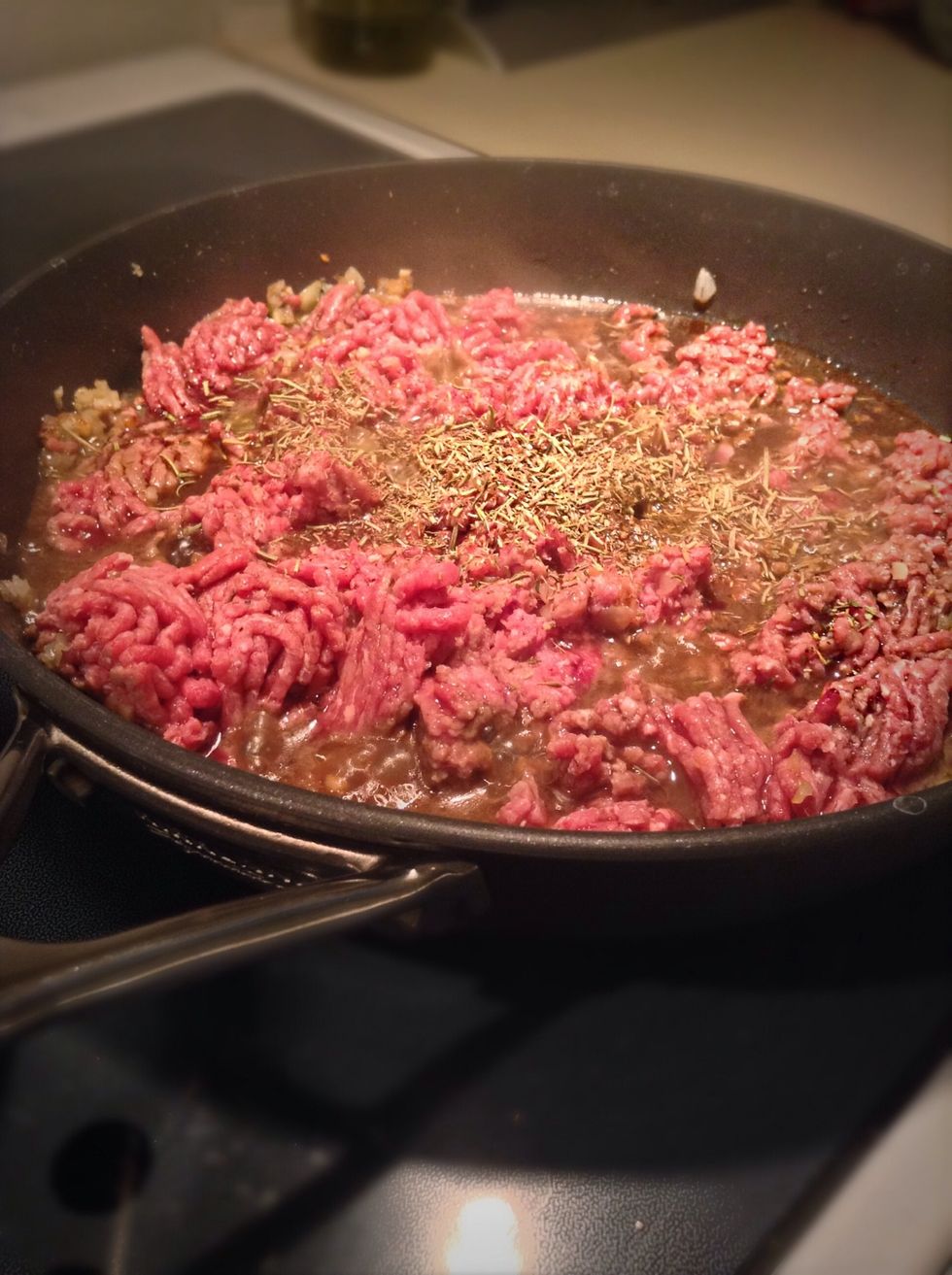 Once the onion becomes clear add in your beef or lamb, thyme, rosemary and worcestershire sauce. Cook until brown, drain excess fat and place meat back into the pan.