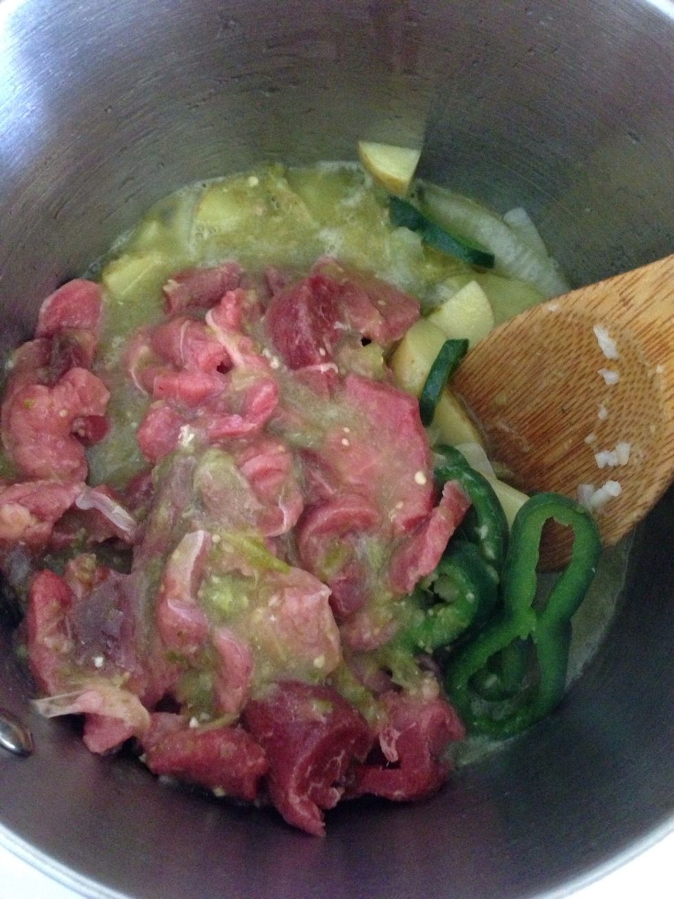 Once the onion is translucent and the potatoes have started to soften up a bit, add the meat and the chili. Lower the flame and cover. Occasionally stir. Cook for about 20-30 minutes.