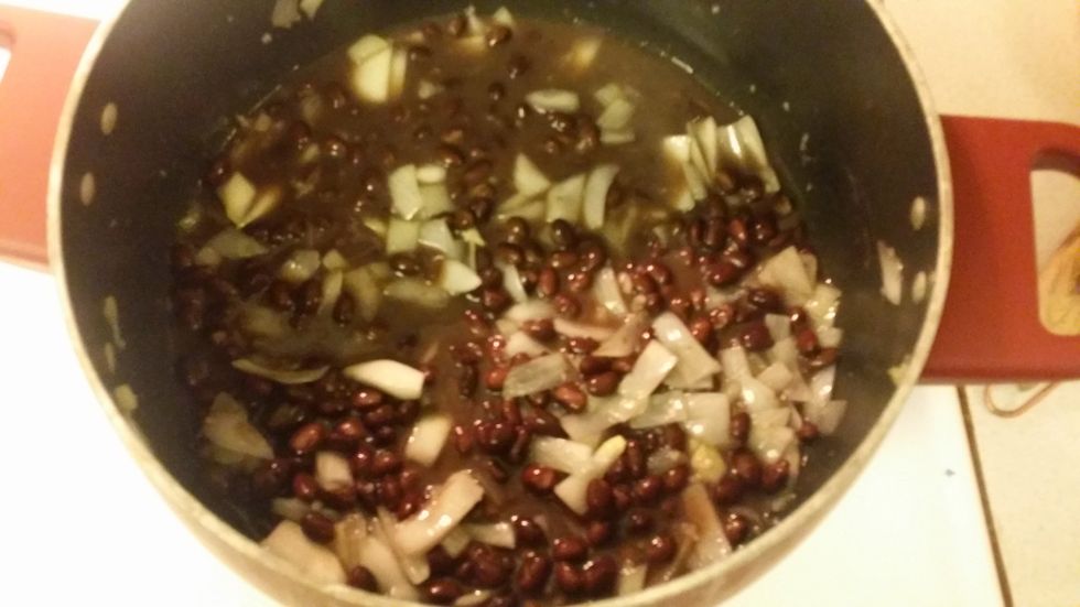 once the onions are soft, add an undrained can of black bean