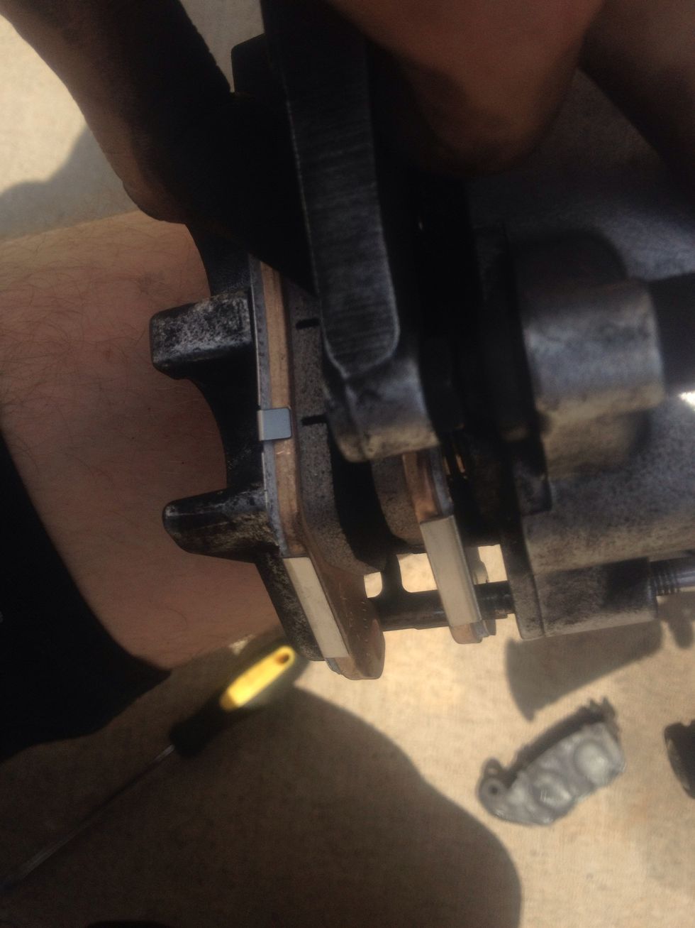 Once the pads are sitting in caliper (make sure the shape of the pads flow with the caliper and rotor) insert the pin to hold pads into place