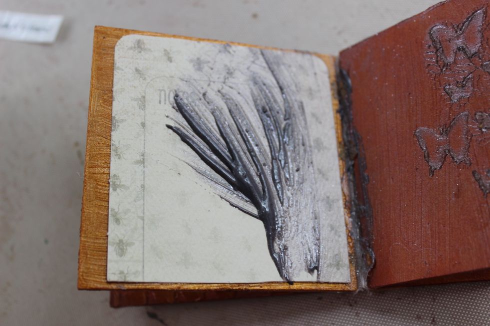 Once the pages where dry I went ahead and started embellishing them. On this page I actually spread some Trolley Grey over the paper I had glued to the page.