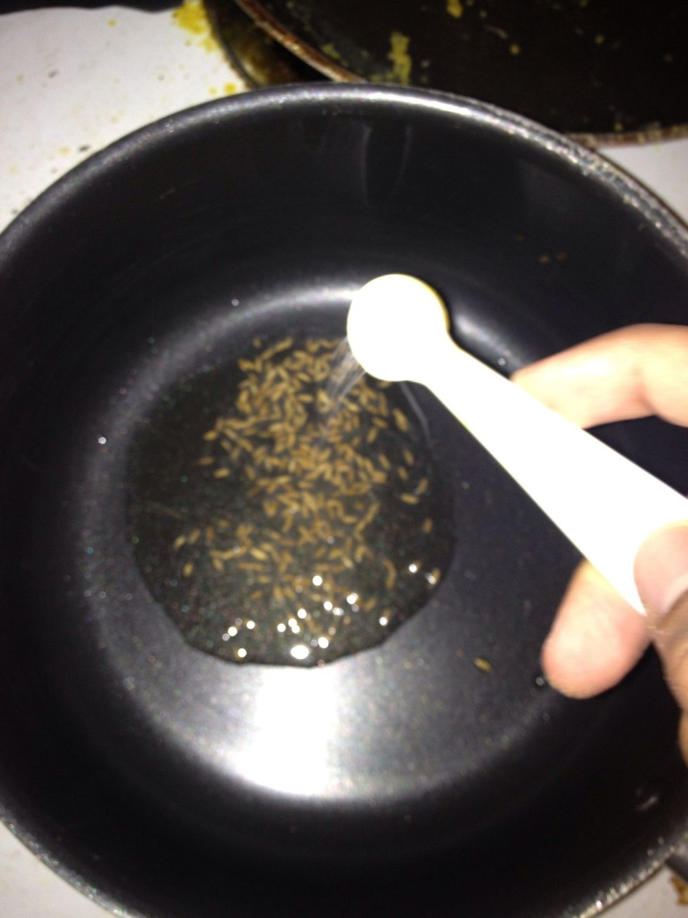 Once the pan is hot, add the Cumin seeds and let them sizzle.