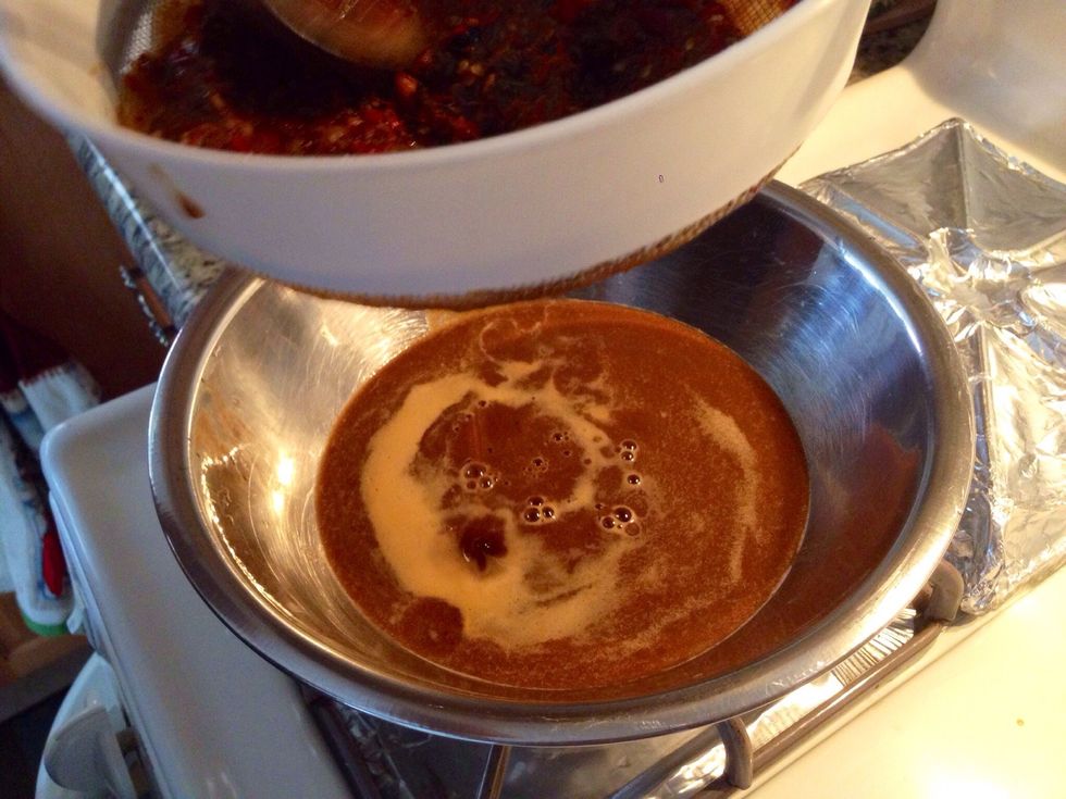 Once the peppers are done, you want to blend and strain the peppers and water together. Leaving you with this chili mix. This is what makes your Pozole delicious and authentic.