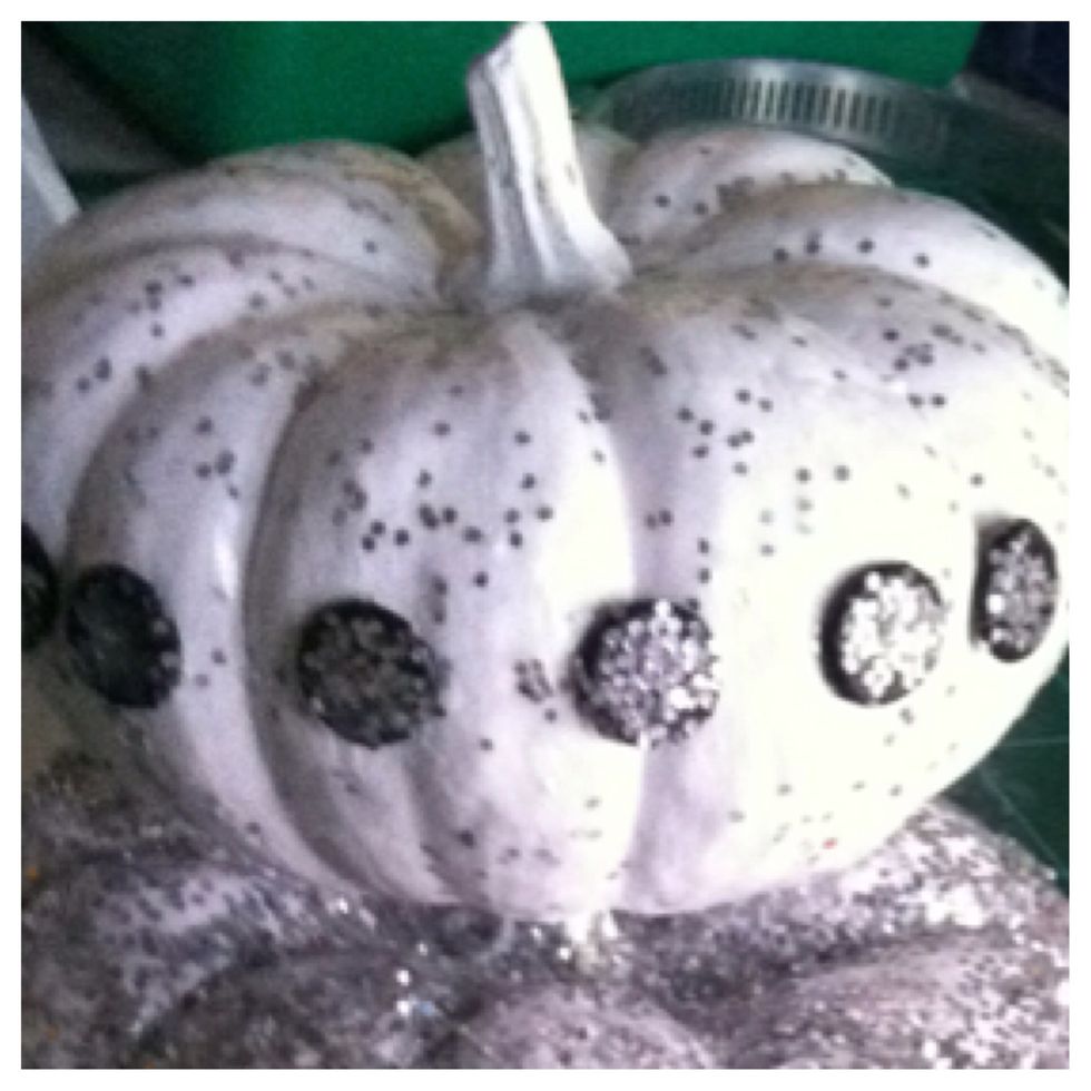 Once the pins are dry, simply push them into the pumpkin then add another coat of Mod Podge to seal. I mixed a little MP and glitter and painted the entire surface.