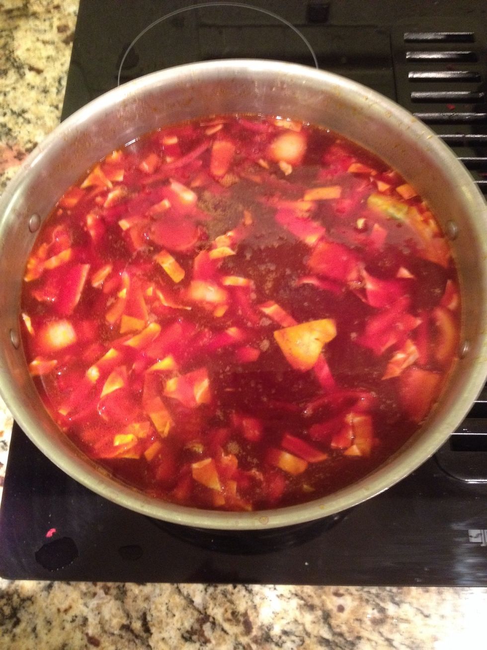 Once the pork is halfway cooked, add the vegetables from the skillet, chopped potatoes and the can of beans to the pot.